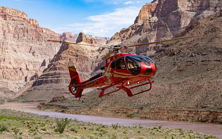 A helicopter landed deep in the Grand Canyon beside the Colorado River