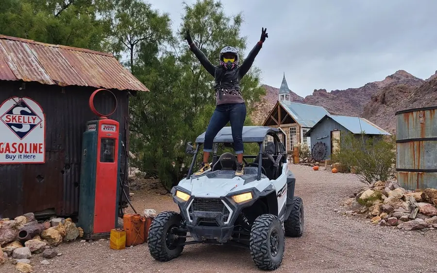 A side-by-side buggy parked at an old west ghost town