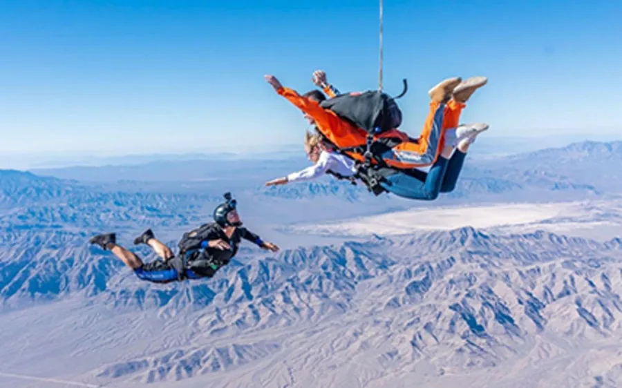 A tandem skydiver in freefall above the Nevada desert